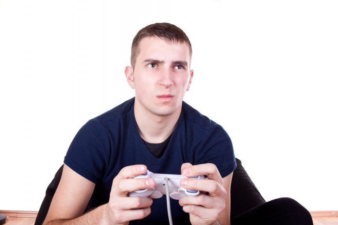 furious young man with a joystick